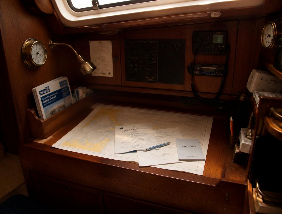 Ship registration papers and a pen on a yacht chart table